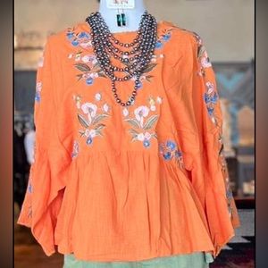 Brand new Orange embroidered flow top size Medium